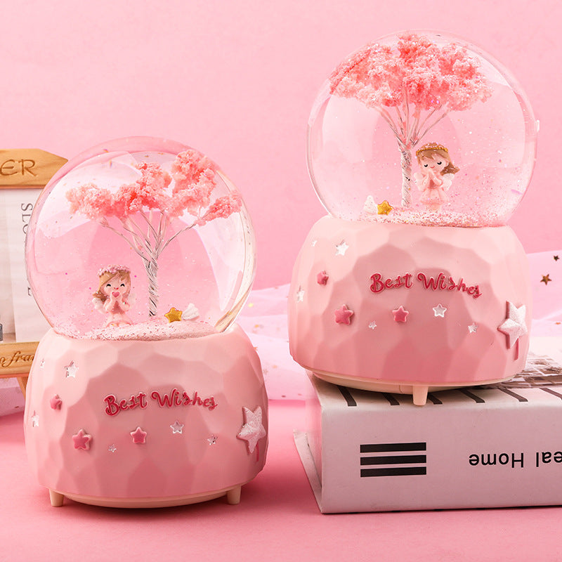 back view snow globe cherry blossom angel