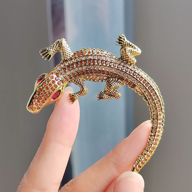 Flat lay photography of crocodile brooch image 8