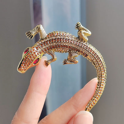 Flat lay photography of crocodile brooch image 8