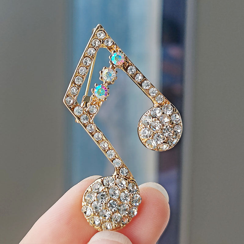 Heart-shaped musical note brooch design